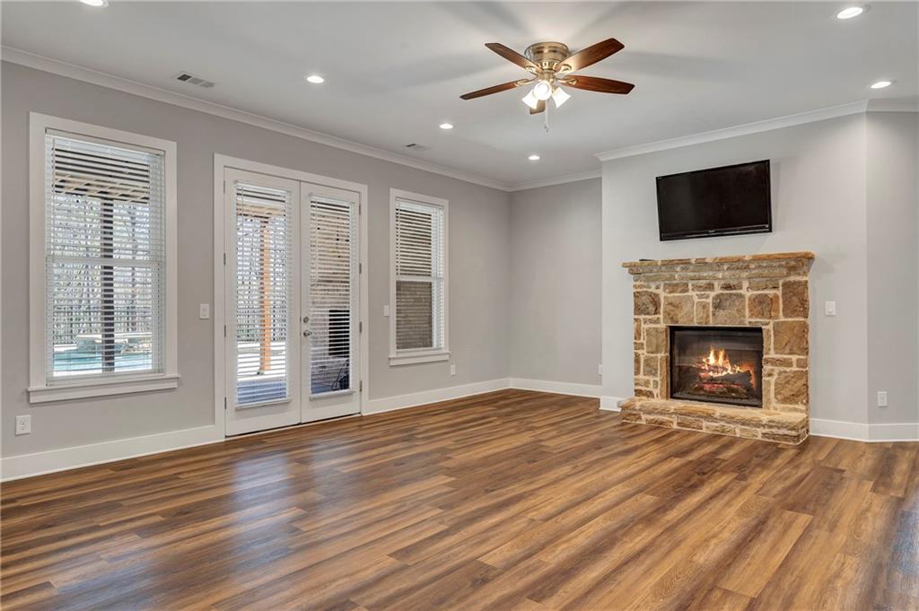 254 Fortress Way Jefferson, GA 30549 - Photo 48 of 69 a view of a livingroom with a fireplace a ceiling fan and a fireplace