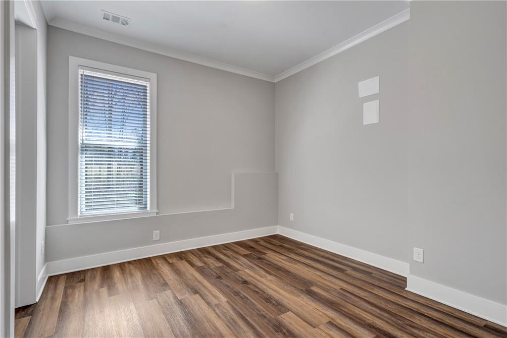 254 Fortress Way Jefferson, GA 30549 - Photo 53 of 69 a view of an empty room with wooden floor and a window