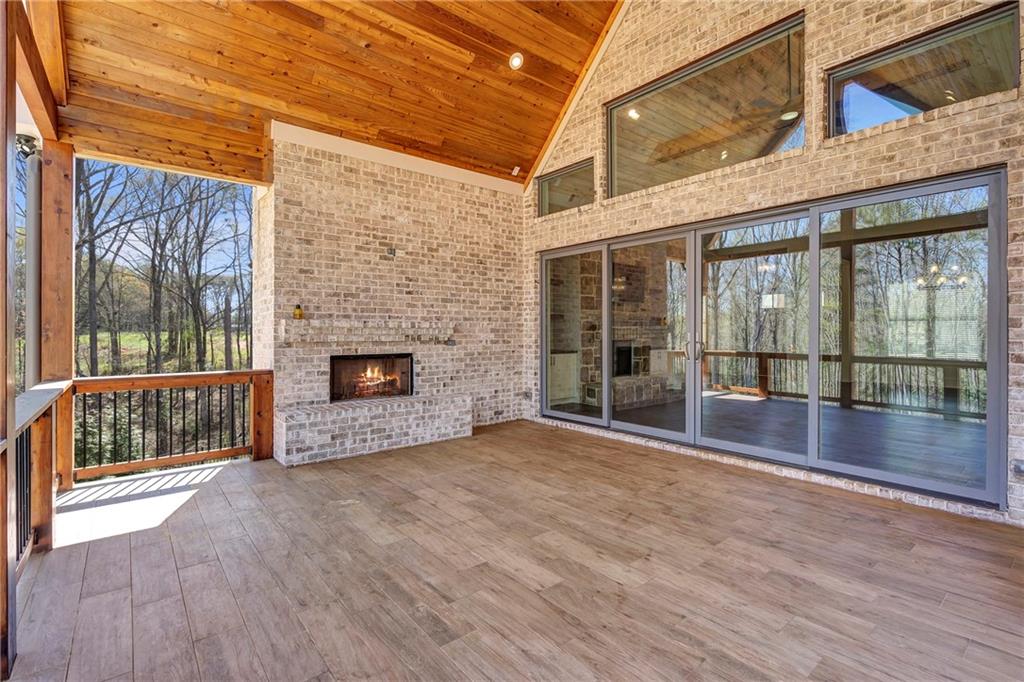 254 Fortress Way Jefferson, GA 30549 - Photo 59 of 69 a view of empty room with wooden floor and fireplace