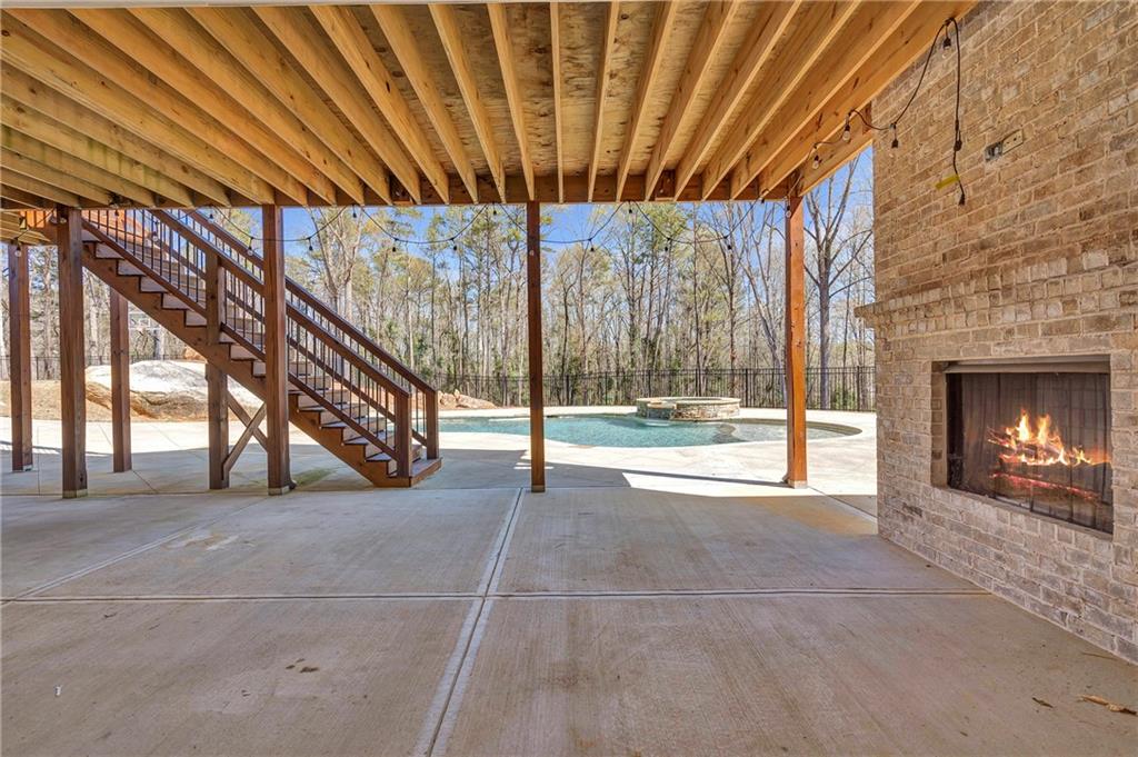 254 Fortress Way Jefferson, GA 30549 - Photo 66 of 69 a view of an empty room with a fireplace and a chandelier