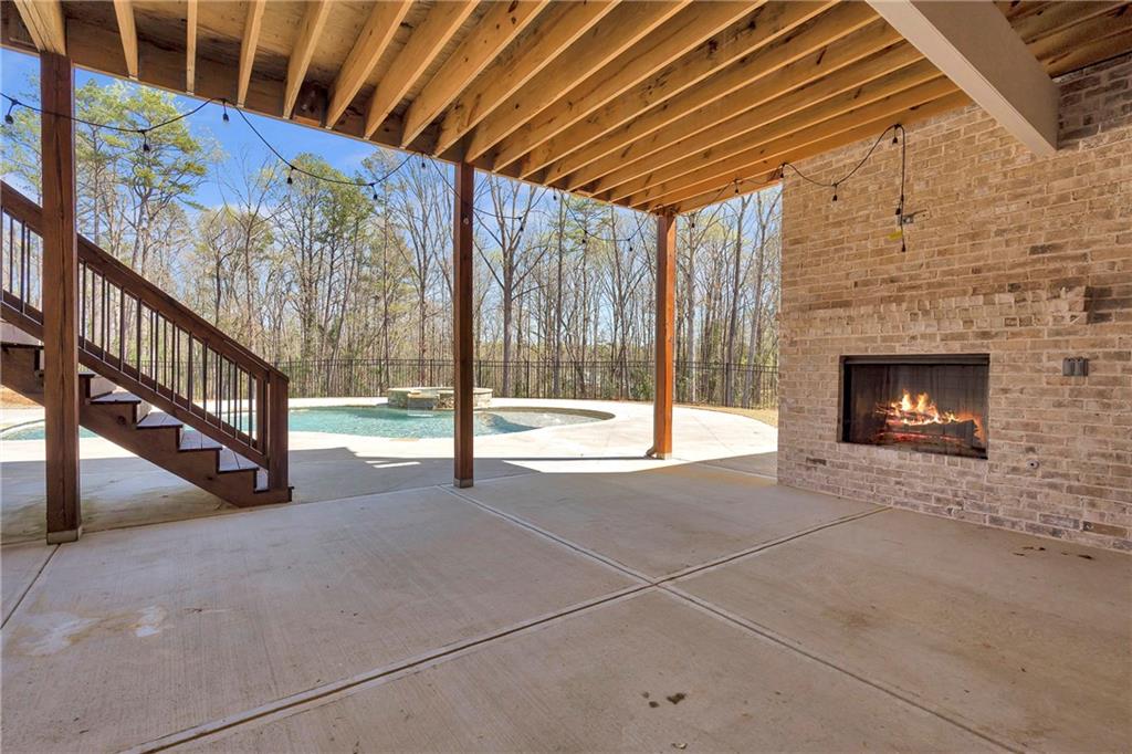 254 Fortress Way Jefferson, GA 30549 - Photo 67 of 69 a view of an empty room with wooden floor and fireplace