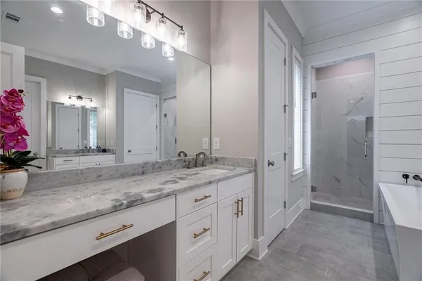 a bathroom with a sink vanity and a mirror