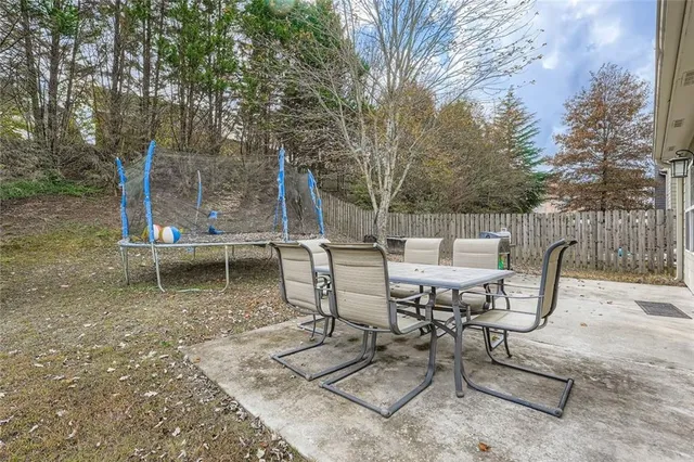 a view of a chairs and table in backyard