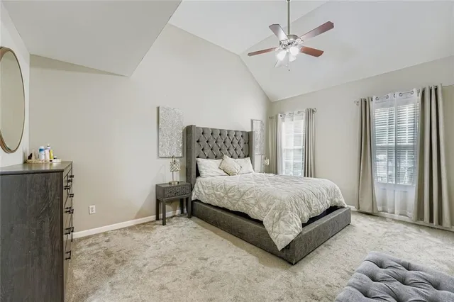 a spacious bedroom with a bed and a chandelier