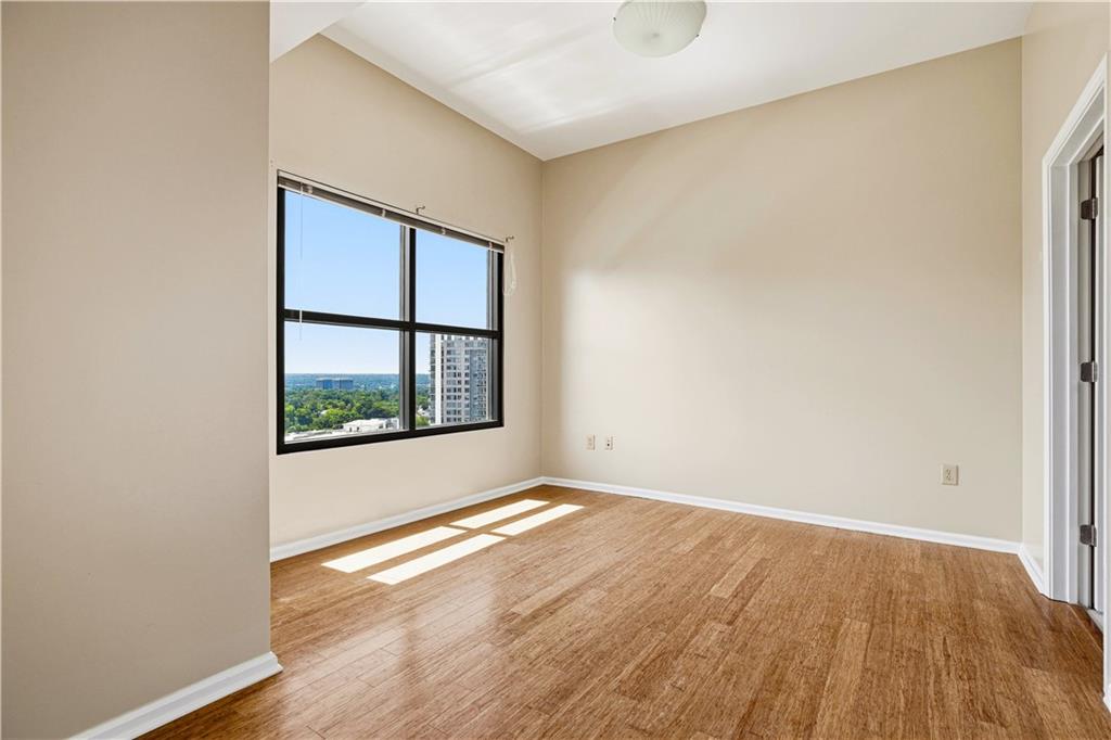 3040 Peachtree Road Northwest, Unit 1503 Atlanta, GA 30305 - Photo 20 of 38 an empty room with wooden floor and windows