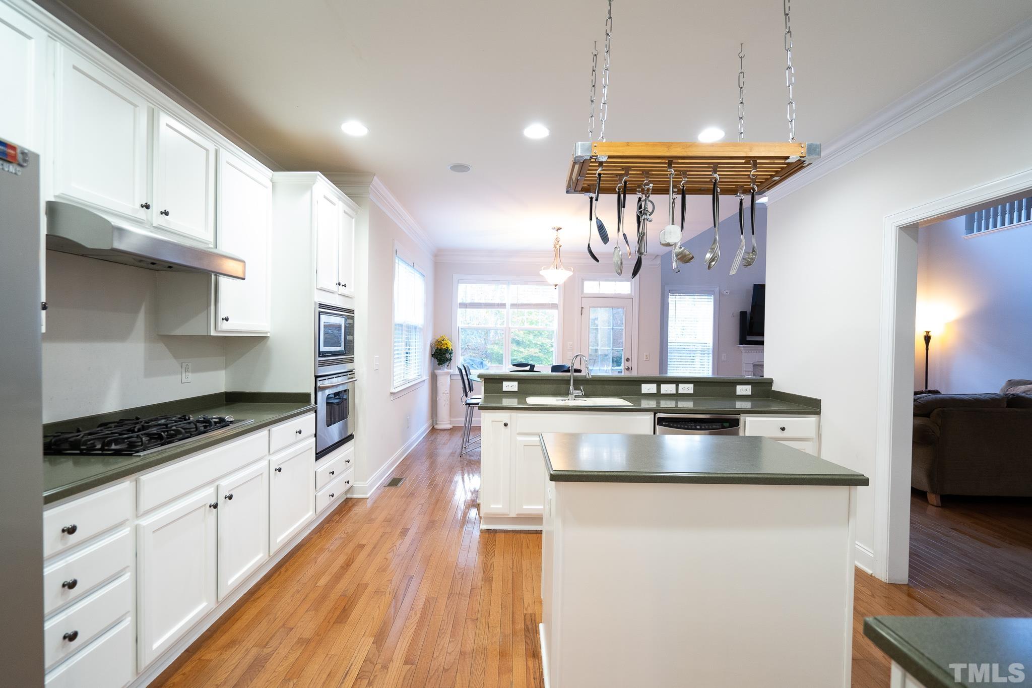 2237 Dunlin Lane Raleigh, NC 27614 - Photo 2 of 13 a kitchen with stainless steel appliances a stove a sink dishwasher and cabinets with wooden floor