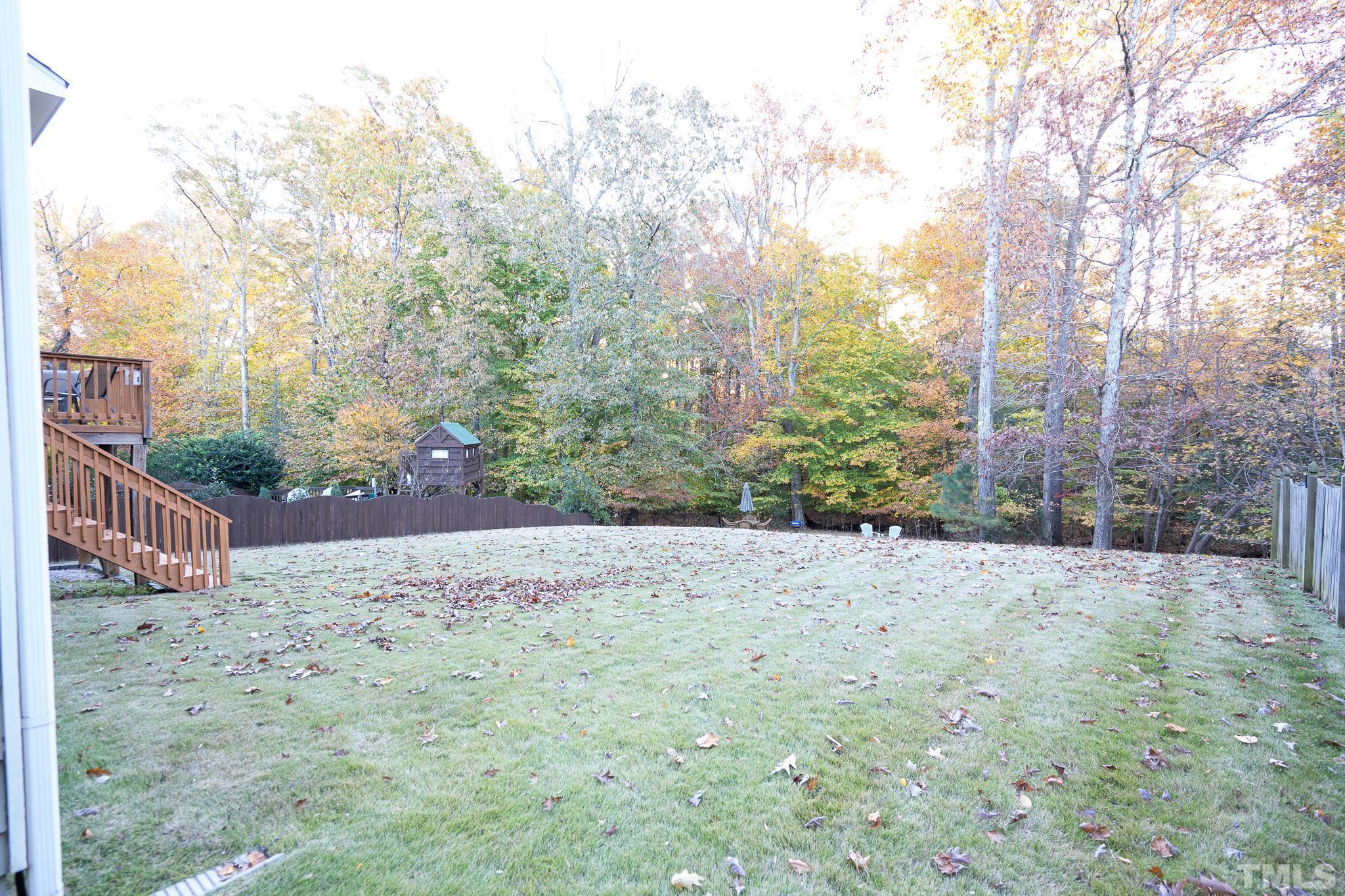 2237 Dunlin Lane Raleigh, NC 27614 - Photo 13 of 13 a wooden bench sitting in middle of a yard