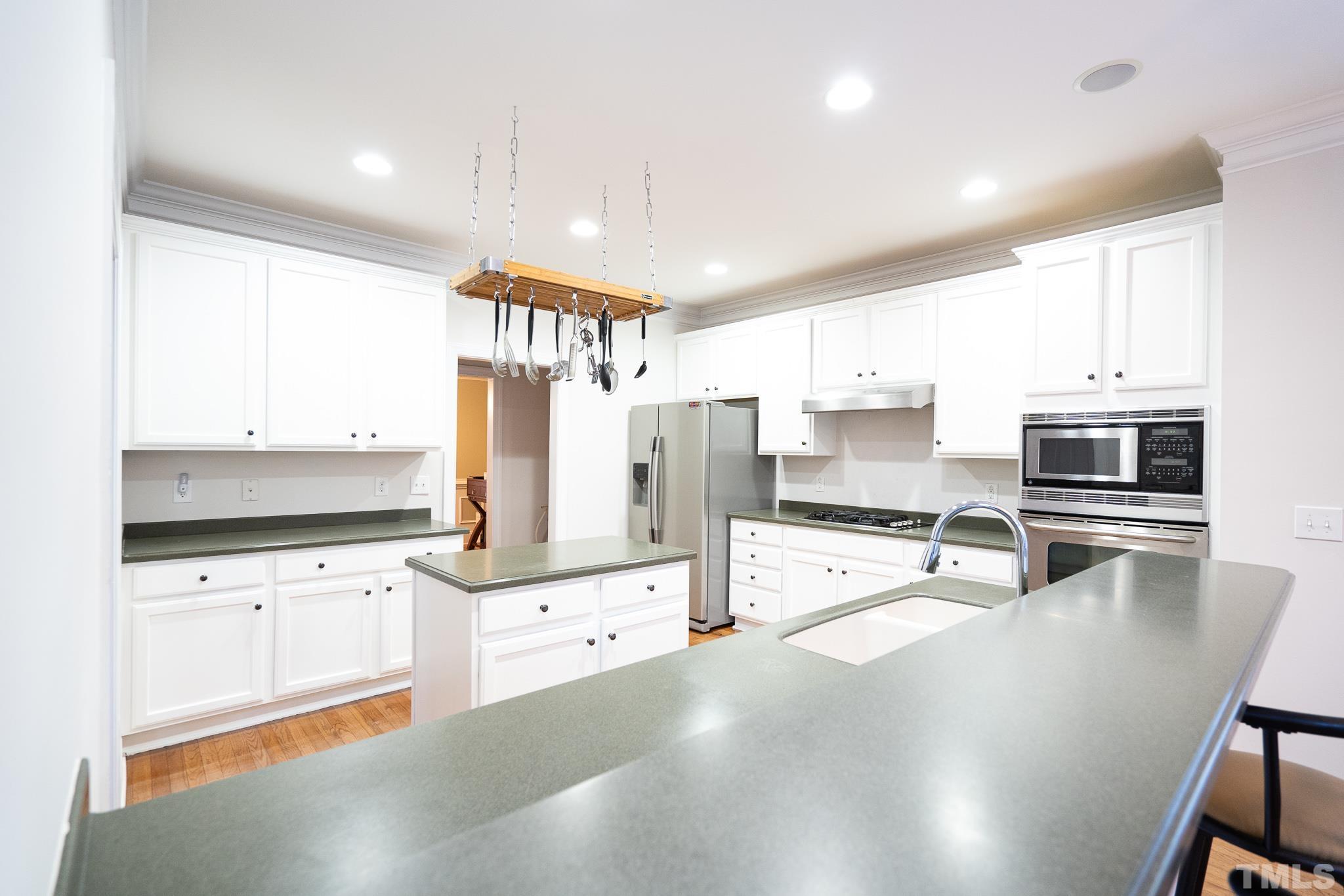 2237 Dunlin Lane Raleigh, NC 27614 - Photo 3 of 13 a kitchen with granite countertop a stove sink and refrigerator