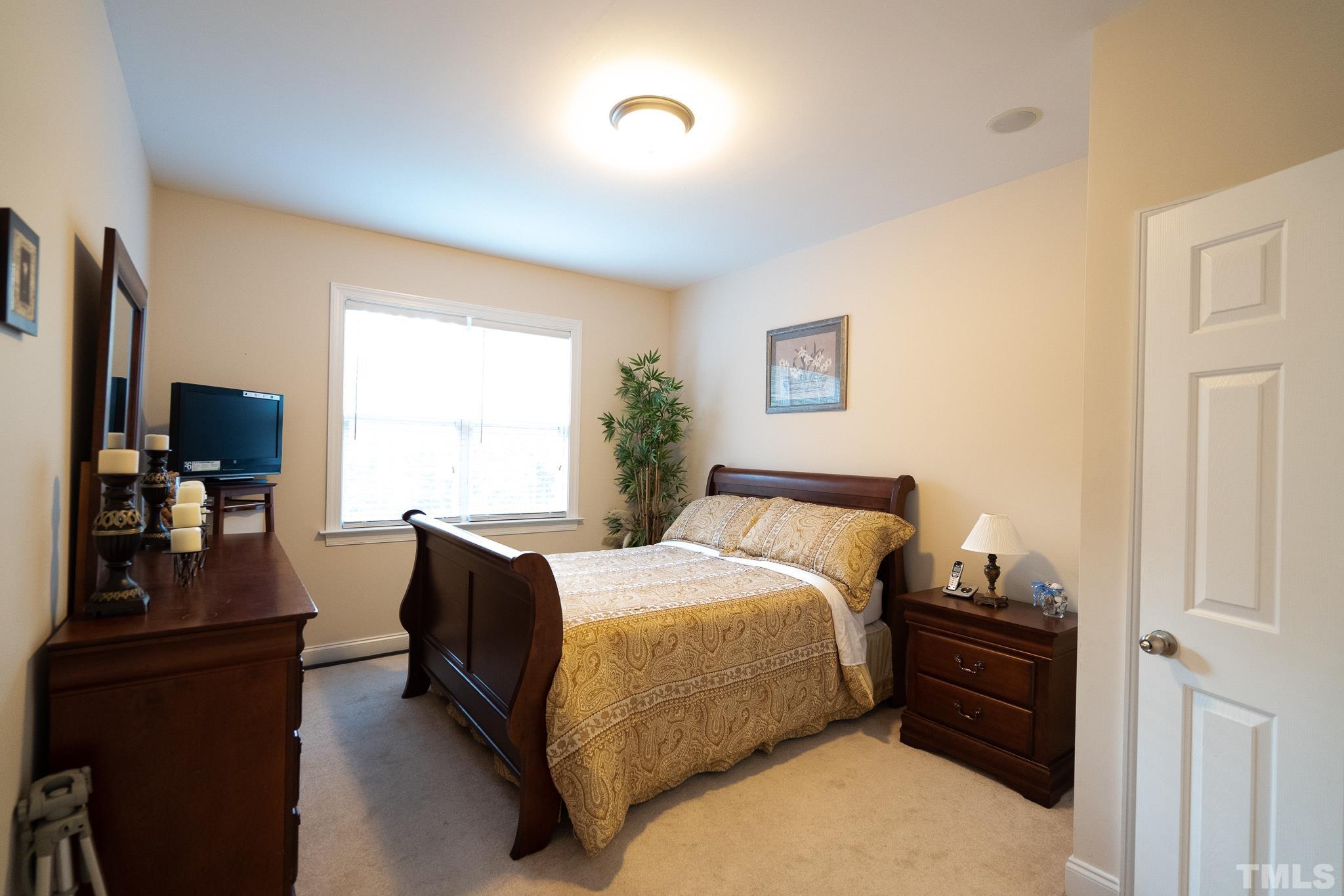 2237 Dunlin Lane Raleigh, NC 27614 - Photo 7 of 13 a bedroom with a bed and wooden floor