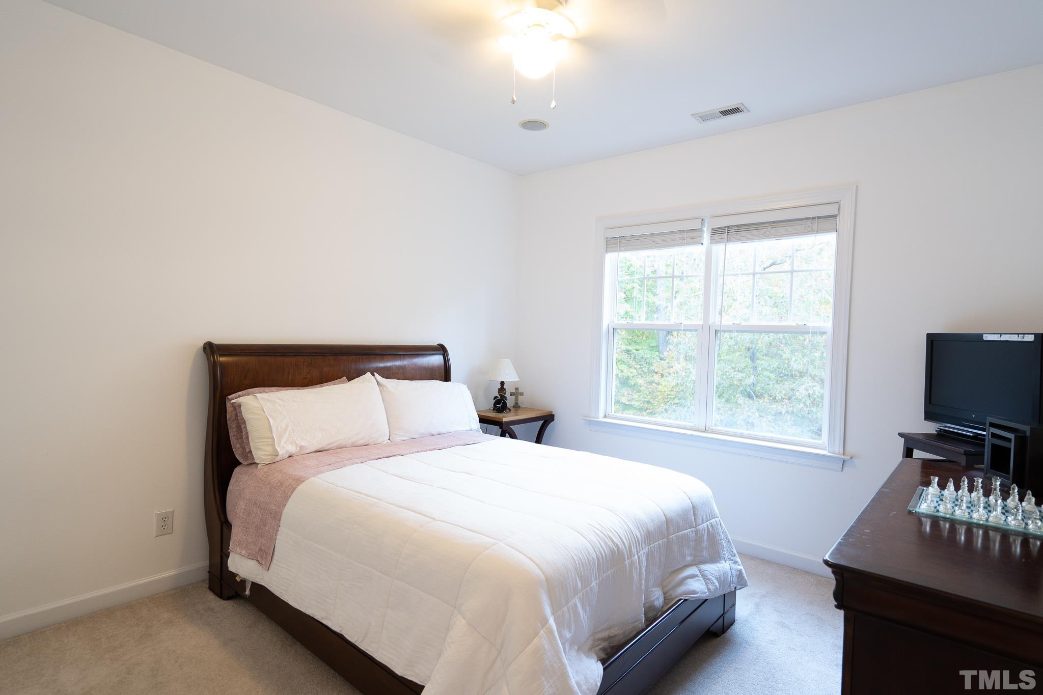 2237 Dunlin Lane Raleigh, NC 27614 - Photo 9 of 13 a bedroom with a bed and flat screen tv