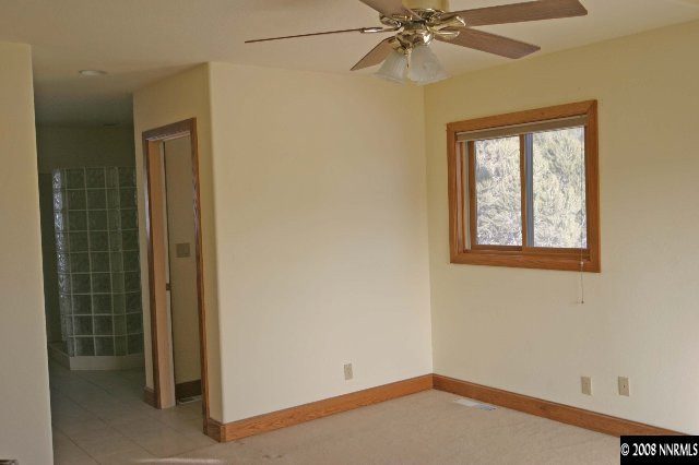 4870 Calavaras Road Reno, NV 89521 - Photo 3 of 9 an empty room with windows and fan