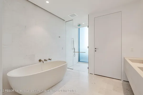 a white bath tub sitting next to a white sink