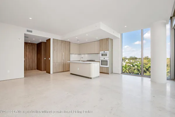 a view of a kitchen with a sink and a refrigerator