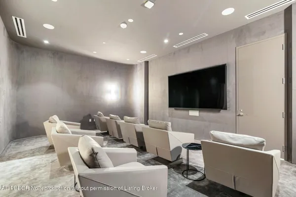 a view of a work space with furniture and floor to ceiling window