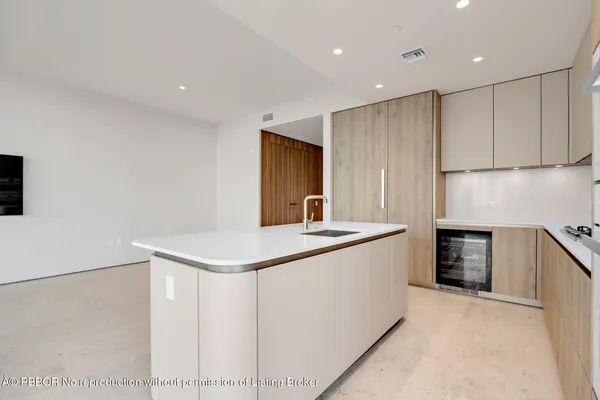 a kitchen that has a sink and a stove in it