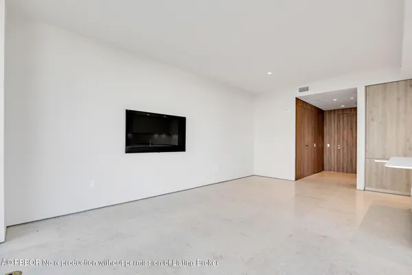a view of a livingroom with an empty space and a fireplace