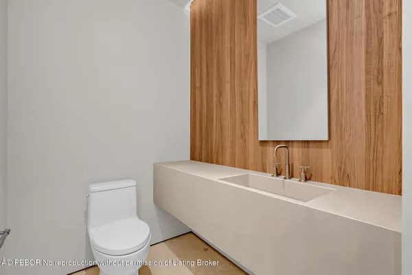 a bathroom with a toilet a sink and a mirror