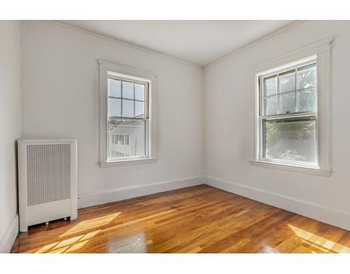 14 Woodbine Road Medford, MA 02155 - Photo 18 of 26 a view of an empty room with wooden floor and a window