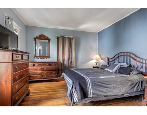 14 Woodbine Road Medford, MA 02155 - Photo 21 of 26 a bedroom with a bed and flat tv screen on the dresser