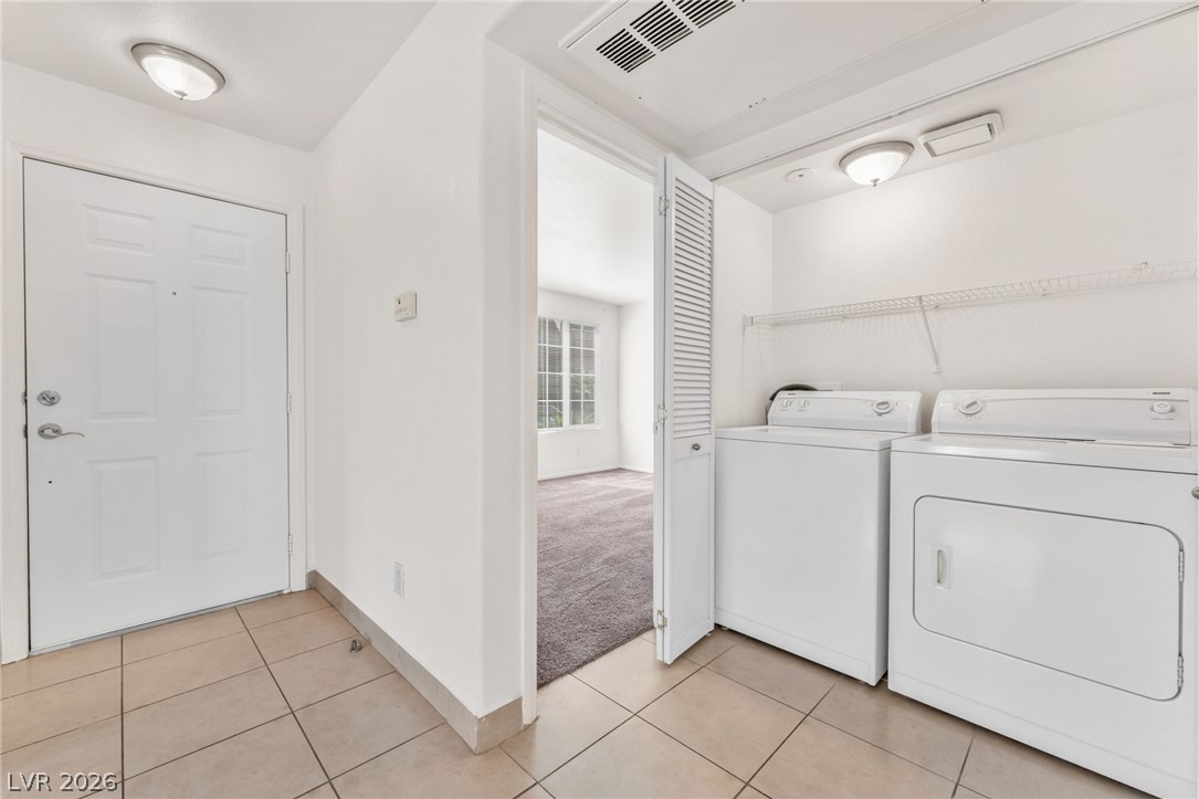 9325 West Desert Inn Road, Unit 177 Las Vegas, NV 89117 - Photo 19 of 24 Functional tile flooring transitions seamlessly from the entry to a dedicated in-unit laundry area.