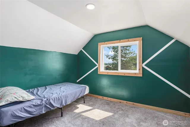 a bedroom with bed and a window