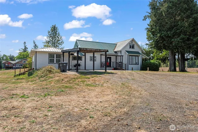 a front view of house with yard outdoor seating and barbeque oven