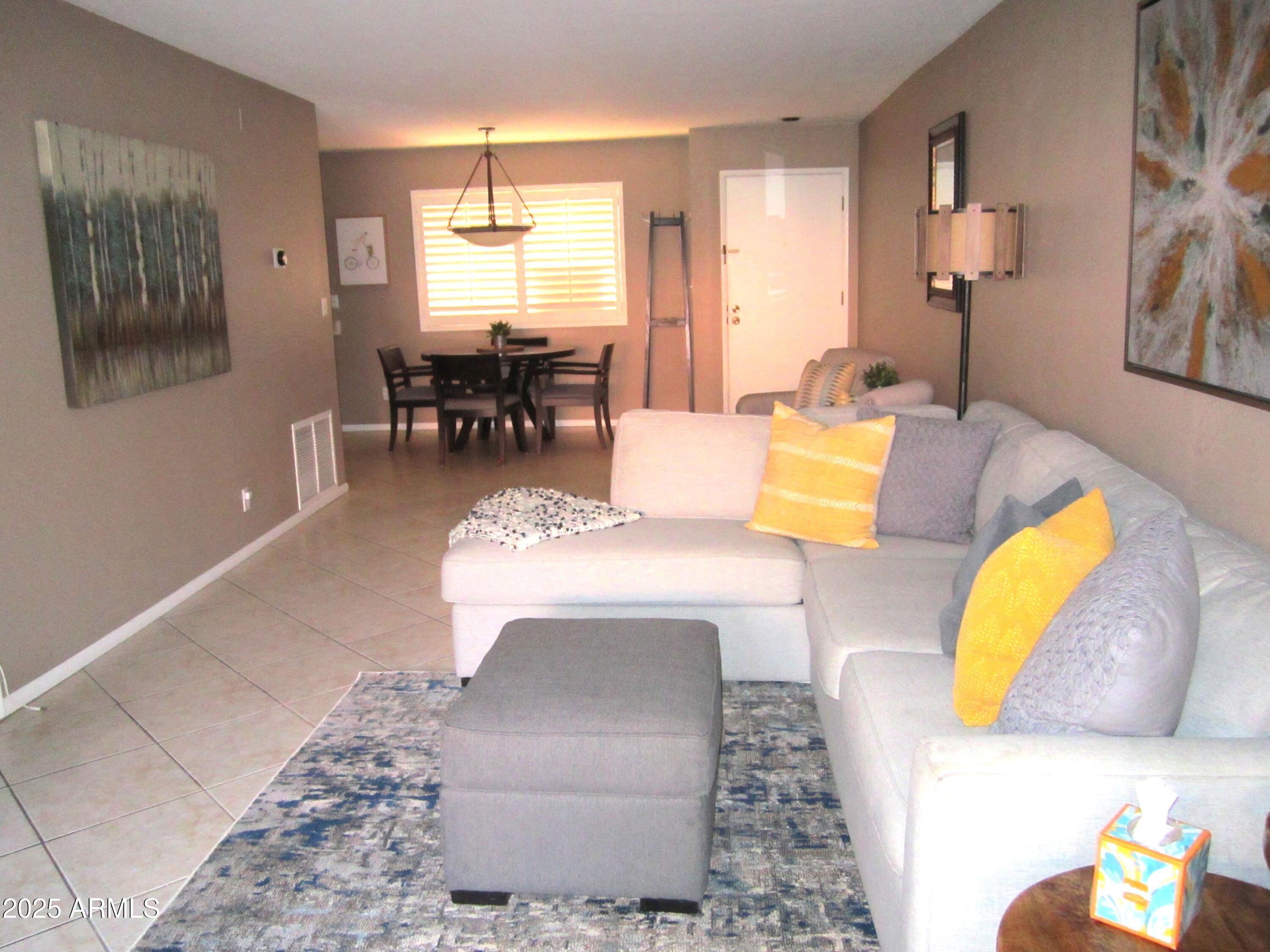 4303 East Cactus Road, Unit 116 Phoenix, AZ 85032 - Photo 6 of 35 a living room with furniture and a table