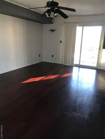a view of room with window and wooden floor