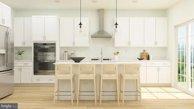 a white kitchen with white cabinets and stainless steel appliances