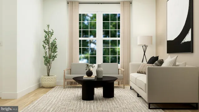 a living room with furniture and a potted plant