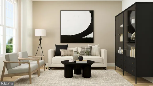 a living room with furniture a lamp and a potted plant