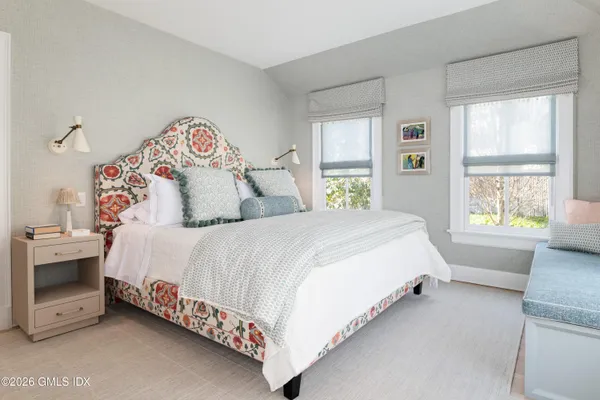 a bedroom with a bed dresser and a window