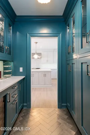 a large white kitchen with a large window