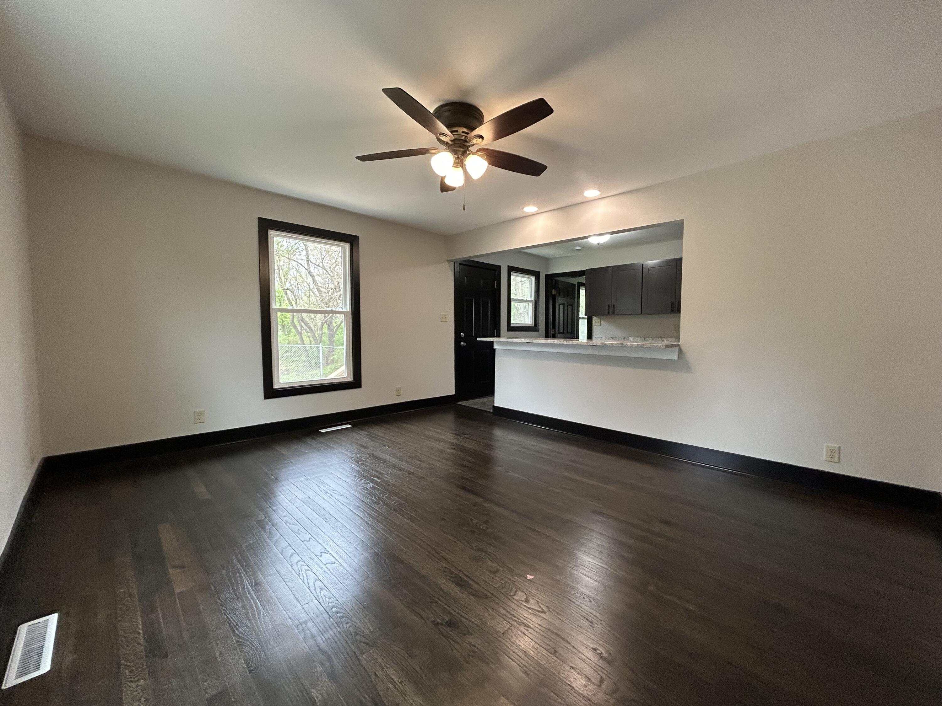 2264 Crest Road Gary, IN 46408 - Photo 24 of 86 a view of a livingroom with a ceiling fan and wooden floor