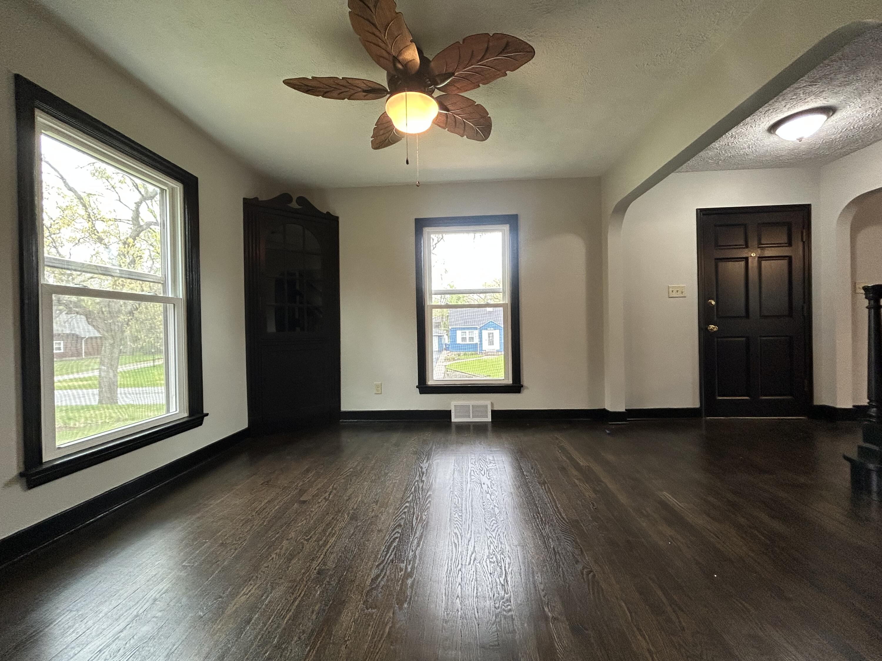 2264 Crest Road Gary, IN 46408 - Photo 38 of 86 a view of an empty room with wooden floor and a window