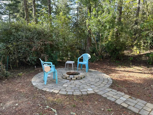 a view of a chair and table in the backyard