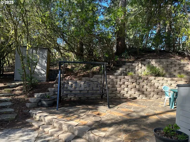 a view of a yard with wooden fence