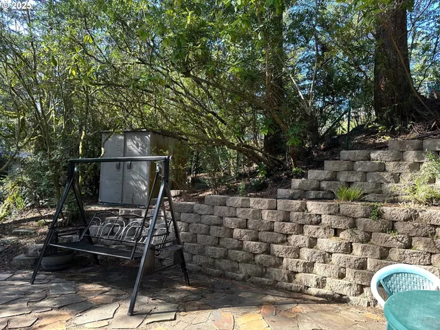 a backyard of a house with barbeque oven