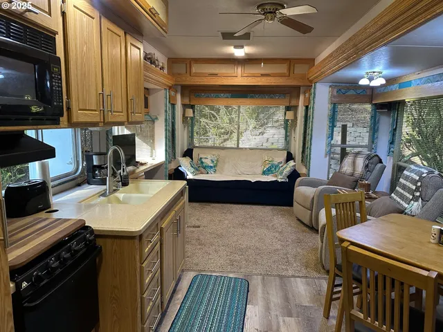 a living room with furniture a large window and flat screen tv