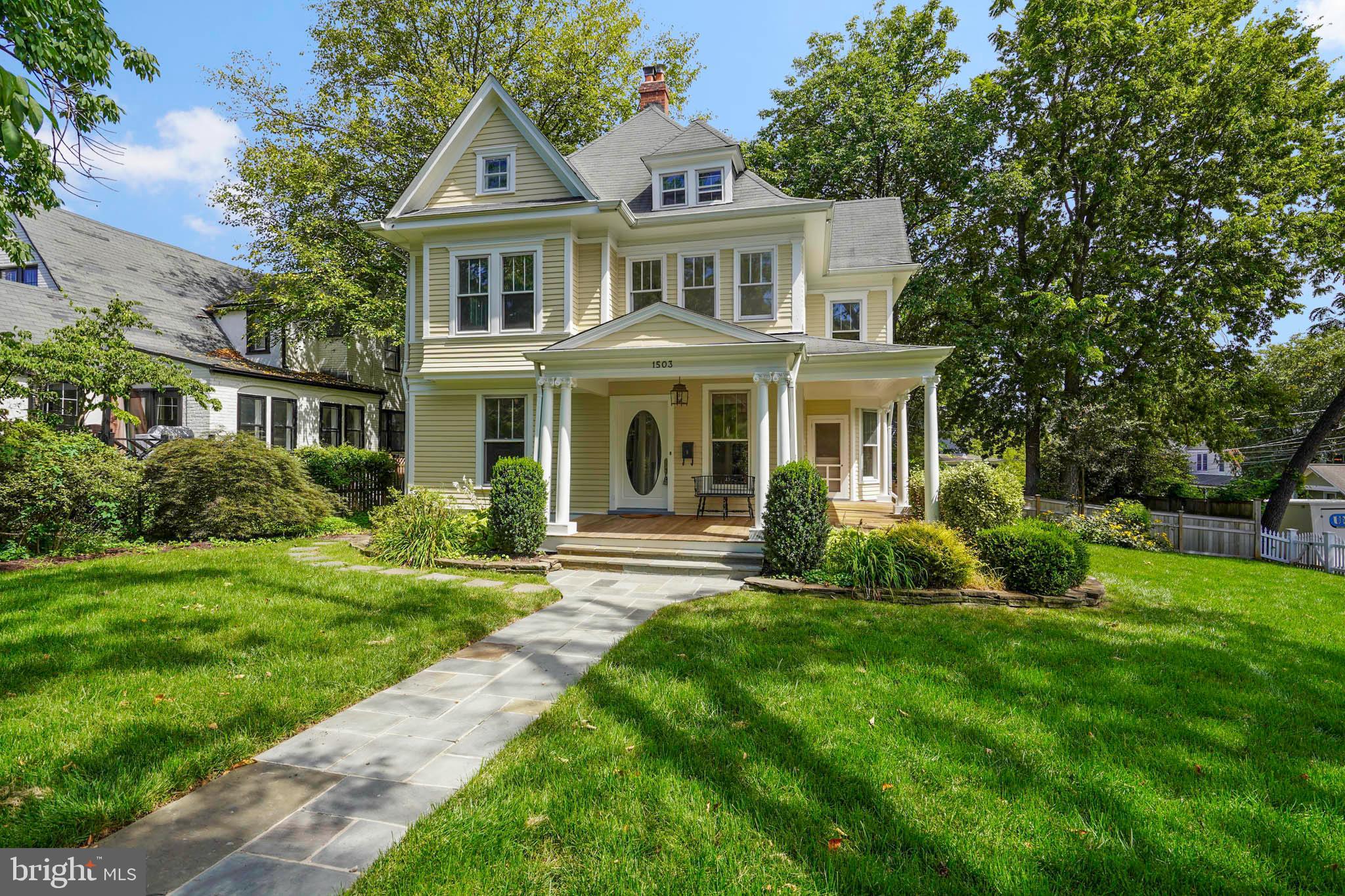 1503 Russell Road Alexandria, VA 22301 - Photo 2 of 39 a front view of a house with a garden and trees