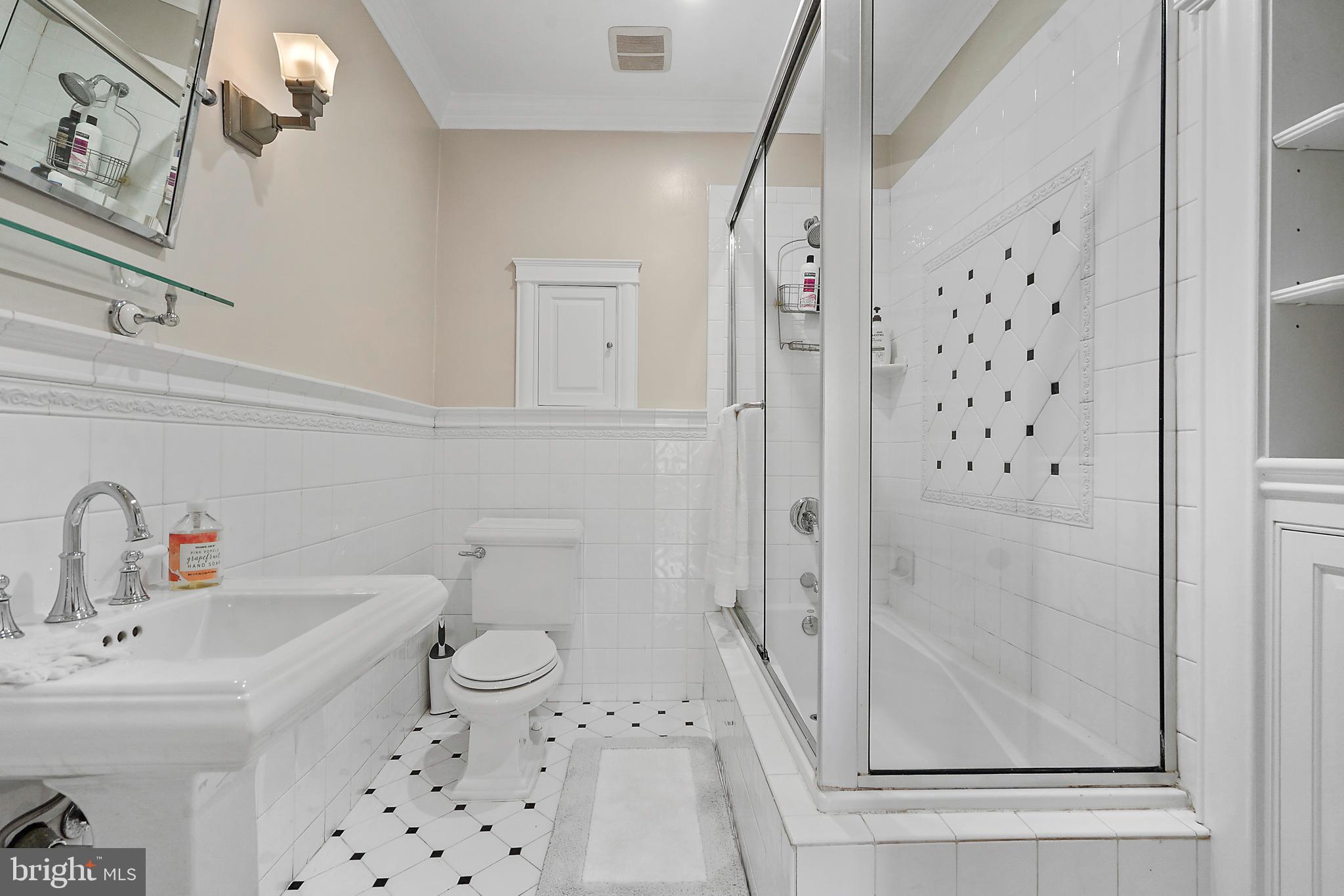 1503 Russell Road Alexandria, VA 22301 - Photo 28 of 39 a bathroom with a sink a toilet and shower