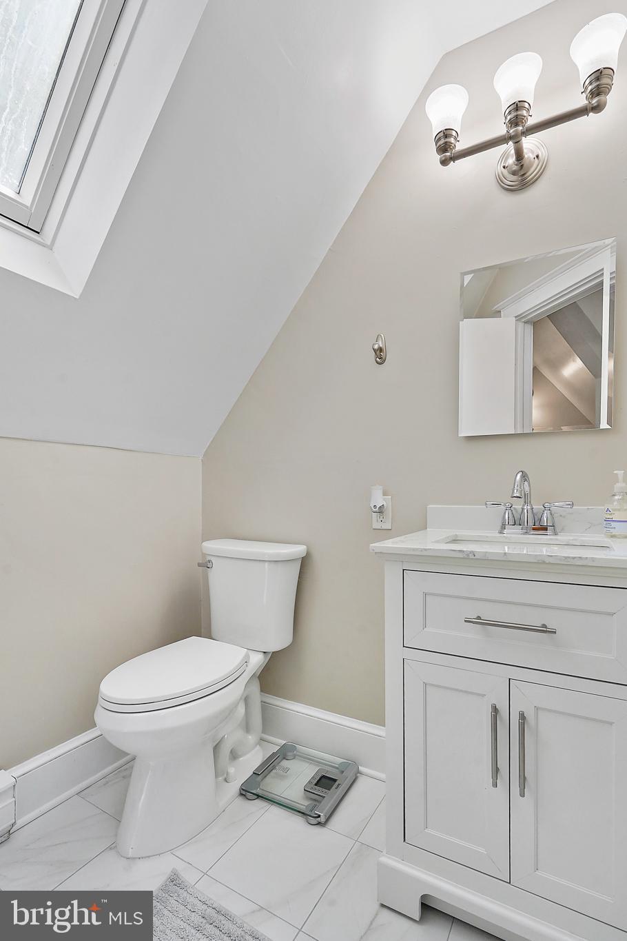 1503 Russell Road Alexandria, VA 22301 - Photo 31 of 39 a bathroom with a sink a toilet a mirror and vanity