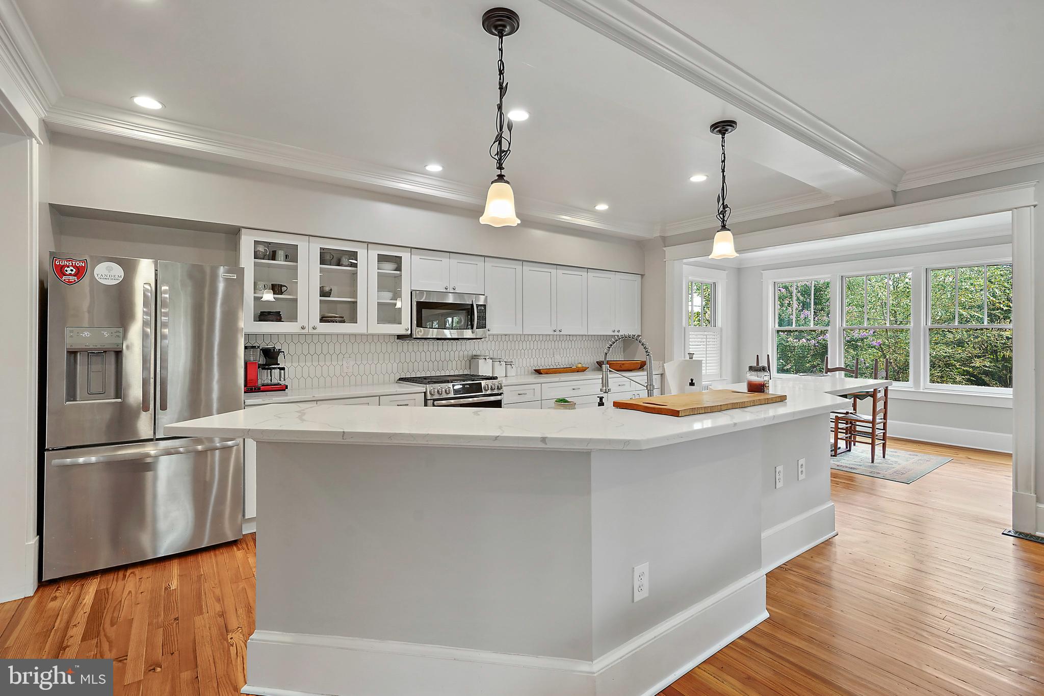 1503 Russell Road Alexandria, VA 22301 - Photo 10 of 39 a large kitchen with kitchen island a large counter space a sink appliances and a large window
