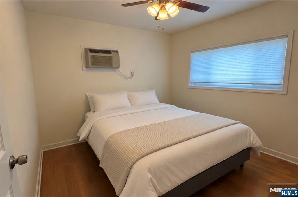 310 Union Street Carlstadt, NJ 07072 - Photo 19 of 24 a bedroom with a bed and a chandelier