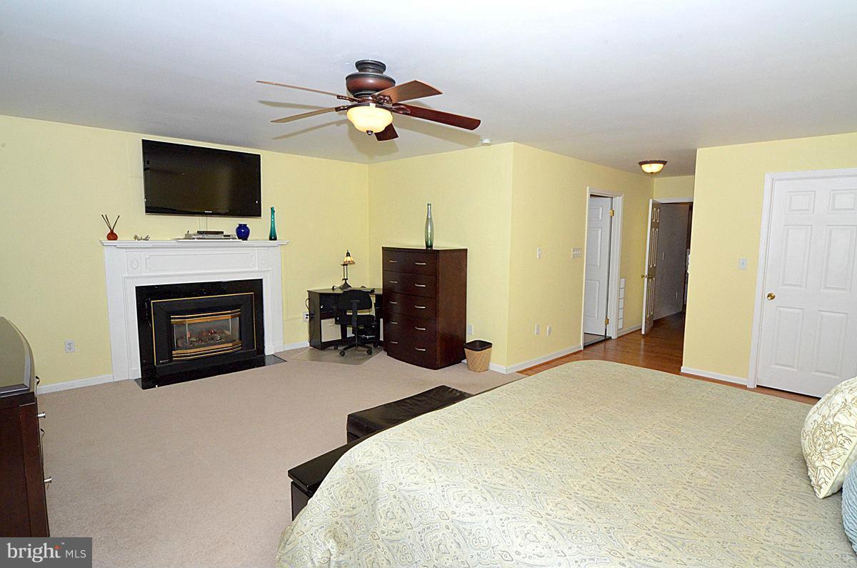7900 Bennett Branch Road Mount Airy, MD 21771 - Photo 14 of 30 a bedroom with a bed and a flat screen tv