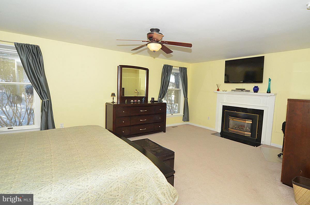 7900 Bennett Branch Road Mount Airy, MD 21771 - Photo 15 of 30 a bedroom with a bed and a flat screen tv