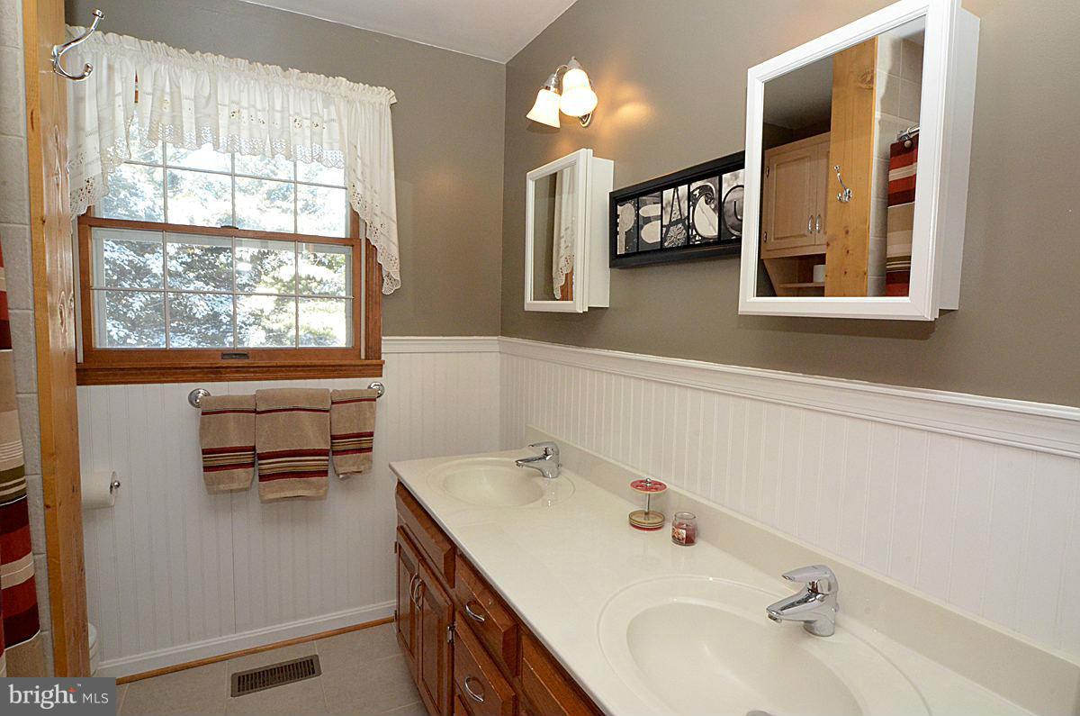 7900 Bennett Branch Road Mount Airy, MD 21771 - Photo 21 of 30 a bathroom with a sink and a mirror