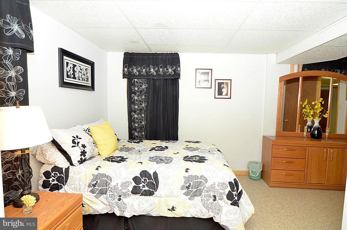 7900 Bennett Branch Road Mount Airy, MD 21771 - Photo 22 of 30 a bedroom with a bed and a dresser