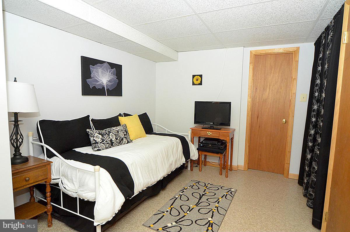 7900 Bennett Branch Road Mount Airy, MD 21771 - Photo 23 of 30 a bedroom with bed and a flat screen tv