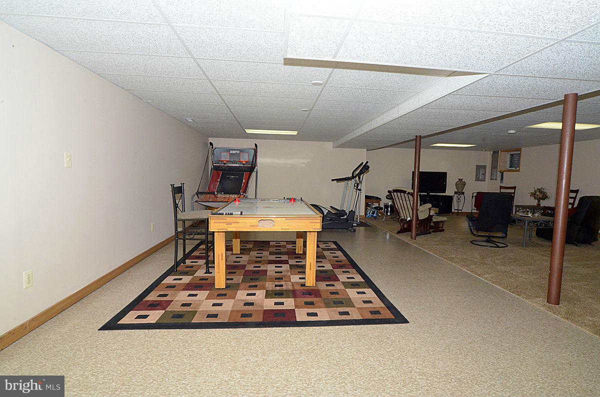 7900 Bennett Branch Road Mount Airy, MD 21771 - Photo 26 of 30 a room with gym equipment and a table